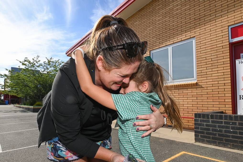 Ella Thompson hugs her mum Carly goodbye on her first day at Holy Spirit School. Picture: MARK JESSER