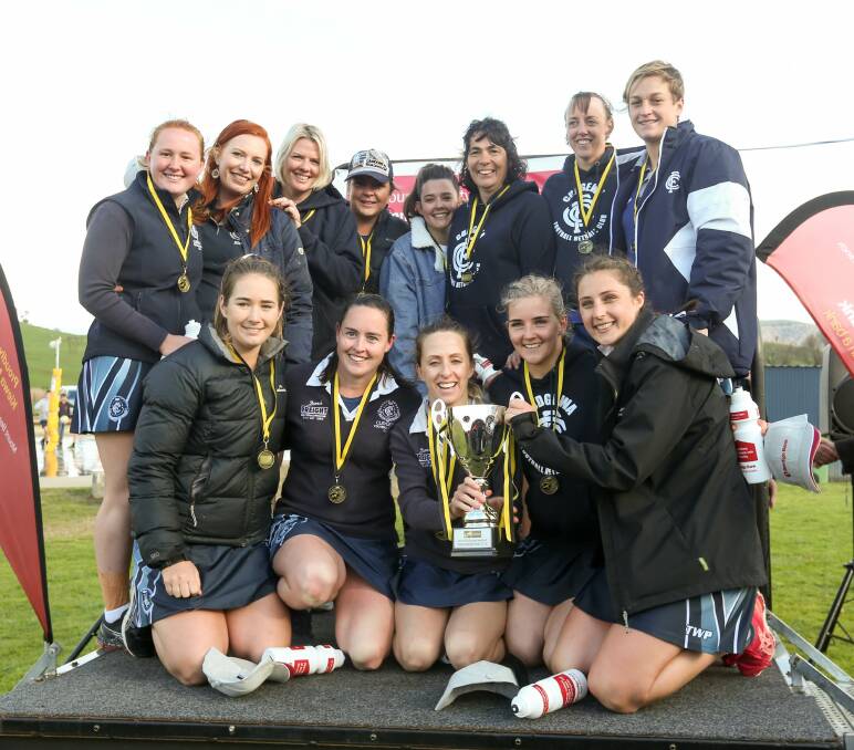 FAIRY TALE ENDING: Cudgewa's grand final winning team with coach Julianne Reiners and the Upper Murray netball cup in Cudgewa on Saturday. Picture: TARA TREWHELLA.