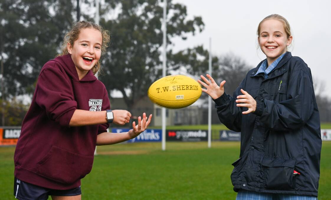 TRAINING PARTNERS: Charlotte Coysh handballs the ball to her twin sister Maya as she prepares to represent the School Sports Victoria under-12 team. Picture: MARK JESSER