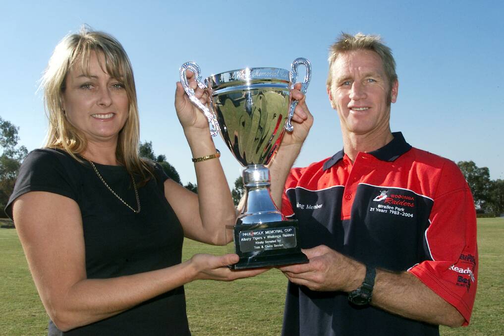 SPECIAL: Ross Hedley and Meg Wolk with the Paul Wolk memorial trophy at Birallee Park in 2005.