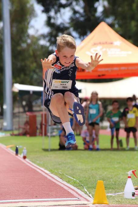 Albury's Jack Godde launches into the air during the under-9's long jump.