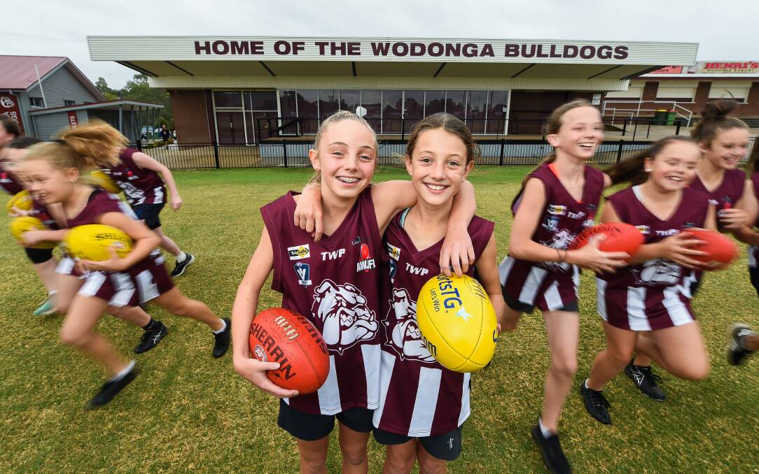 EXCITING TIMES: Friends Mia Thompson and Arhi Cohen are excited to run out onto the field for Wodonga, with the Bulldogs' Junior Football Club set to introduce two girls teams this year. Picture: MARK JESSER
