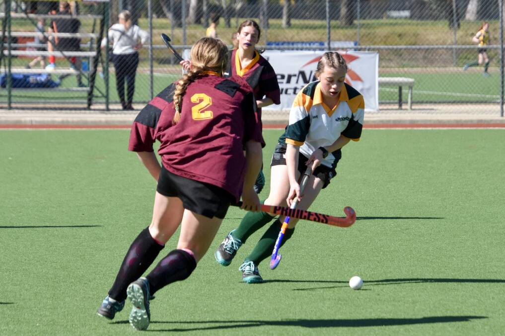 CONCENTRATION: Stephanie Adams does her best to get the ball to safety for her side during Hockey Albury-Wodonga's eight's competition held on the weekend.