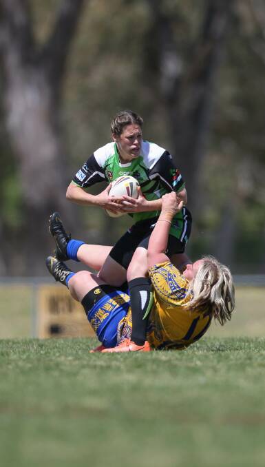 HARD FOUGHT: Thunder's Tenille Ballard fends off a tackle from Yenda's Monique Huggins during the open semi-final at Greenfield Park. Pictures: TARA TREWHELLA.