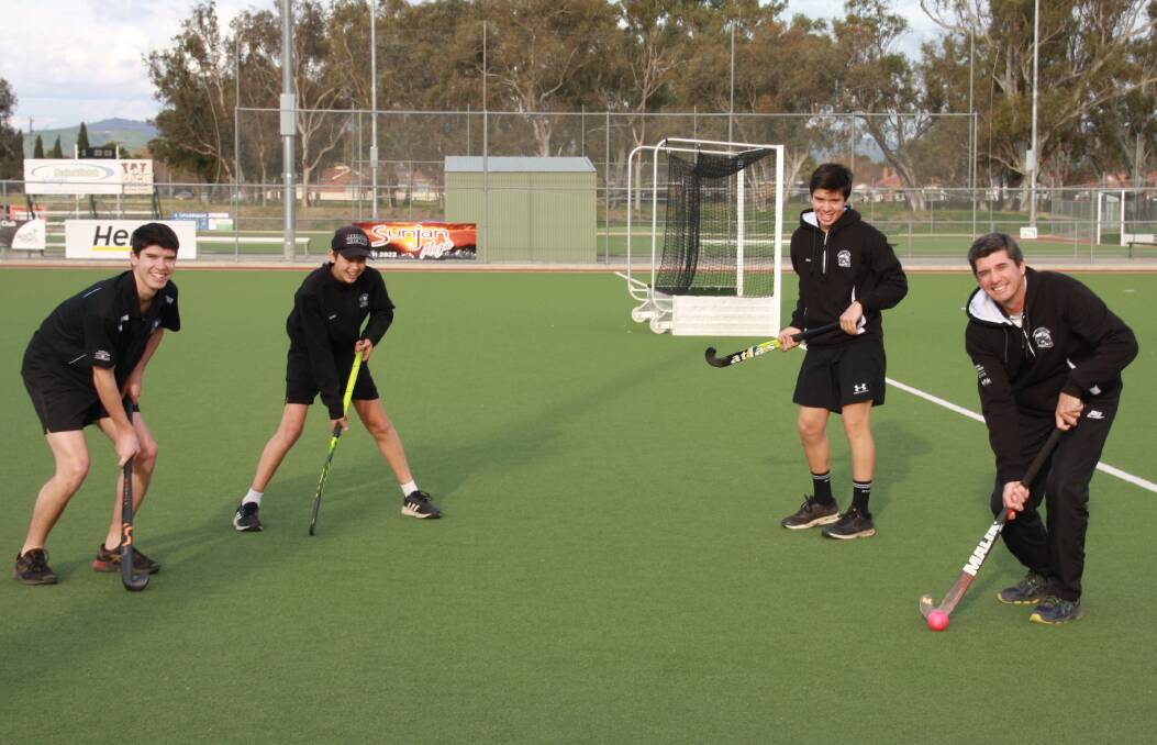 FAMILY AFFAIR: Brothers Lincoln, Hamish and William Morrison feel right at home on the hockey field with their dad Stuart. Picture: ANNE NOLAN