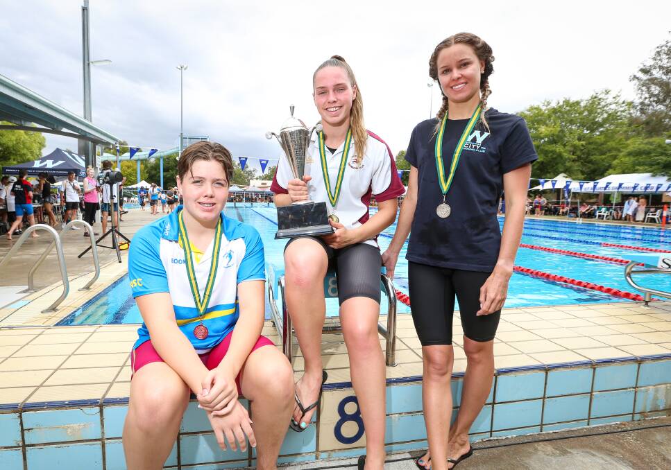 SPECIAL NOD: Ovens and Murray swimmers Brooke King and Mackensey House pictured with overall swimming champion and recipient of the Ben Pascall trophy, Kylie Crofts, during the O and M swimming championships.