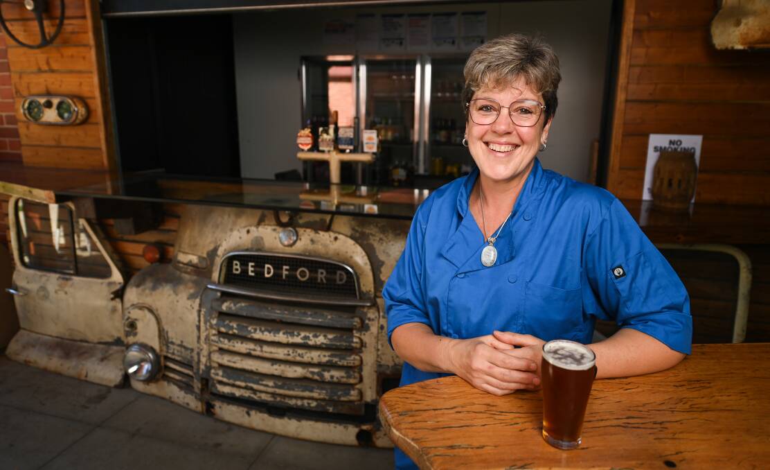 THIRSTY WORK: Mitta Pub co-manager Heather Smith showcases the Bedford Bar. Pictures: MARK JESSER