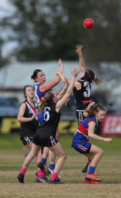 Elizabeth Coulston and Caitlin Gogoll go up for the ball during Thurgoona and Lavington's preliminary final clash on Sunday. 