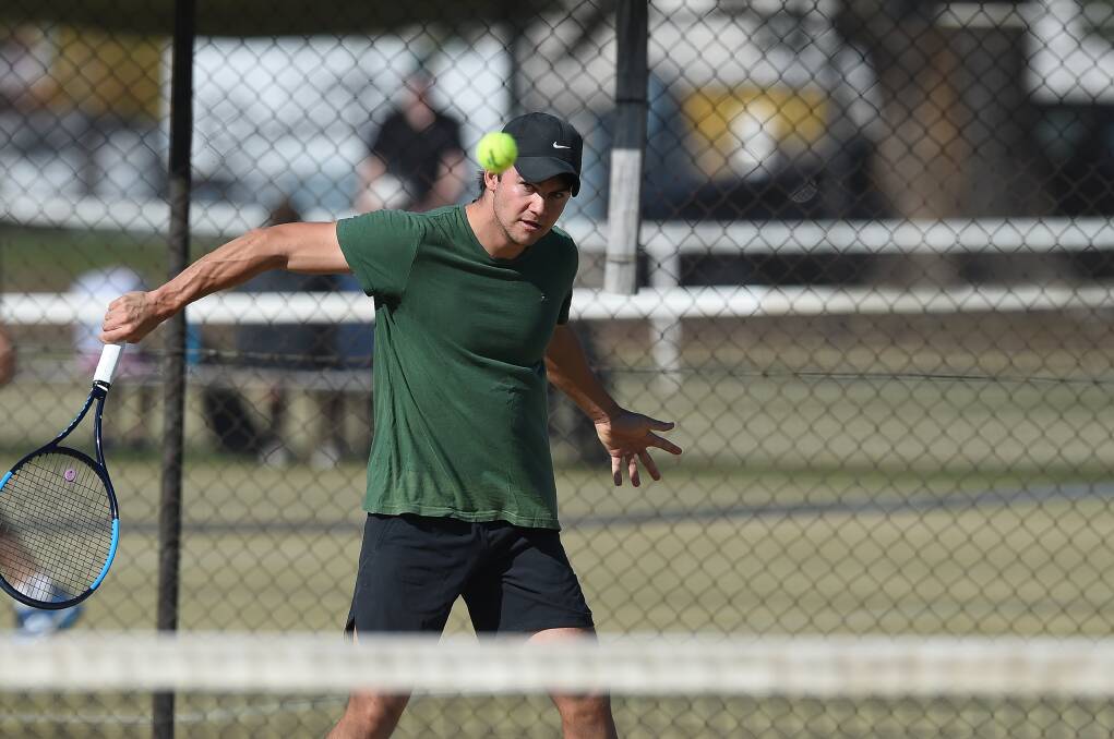 SLICE: Wodonga's Andrew Healy sends a backhand over the net during play at the Albury Easter tournament on Saturday.