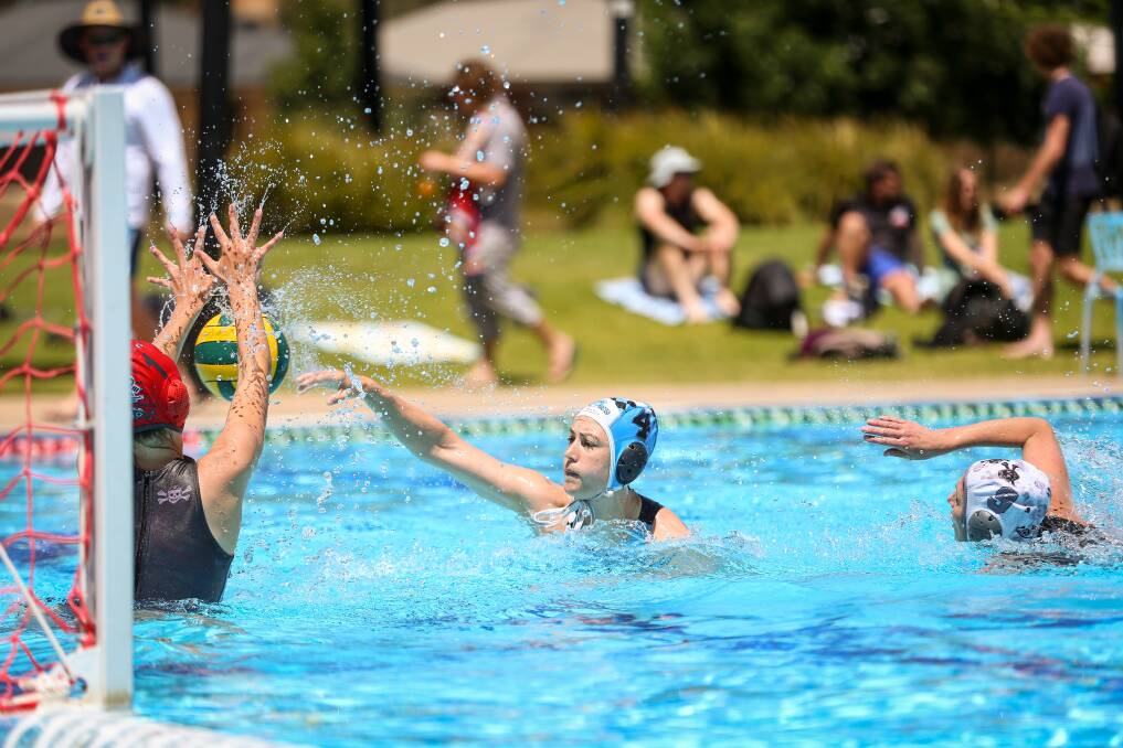 ON TARGET: Sharks' Leah Dodd tries to sneak a goal past Pool Pirates' Eliza Carroll at Wodonga's Waves on Sunday. Picture: JAMES WILTSHIRE.