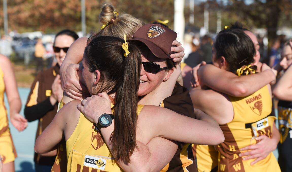 Kiewa-Sandy Creek coach Kath Evans embraces her players after winning the 2019 TDNA A-grade flag.