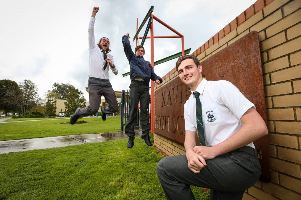 SCHOOL'S OUT: Xavier High School year 12 students Seb Benson (front), Liam Keating and Hogan Quinn were all smiles after finishing their last day of school in Albury on Friday. Picture: JAMES WILTSHIRE