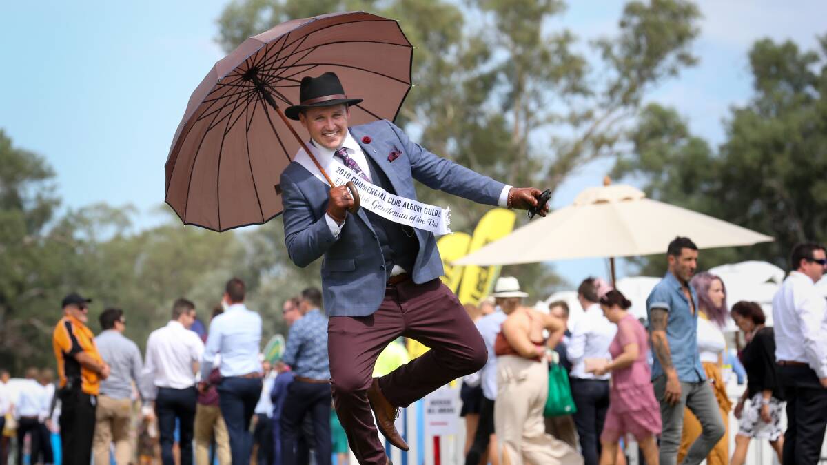 DANCING IN THE RAIN: Fashions on the Field Gentlemen of the Day Jeff Hanson from Tumut won over judges with his brown umbrella and shoes to match. PICTURES: KYLIE ESLER