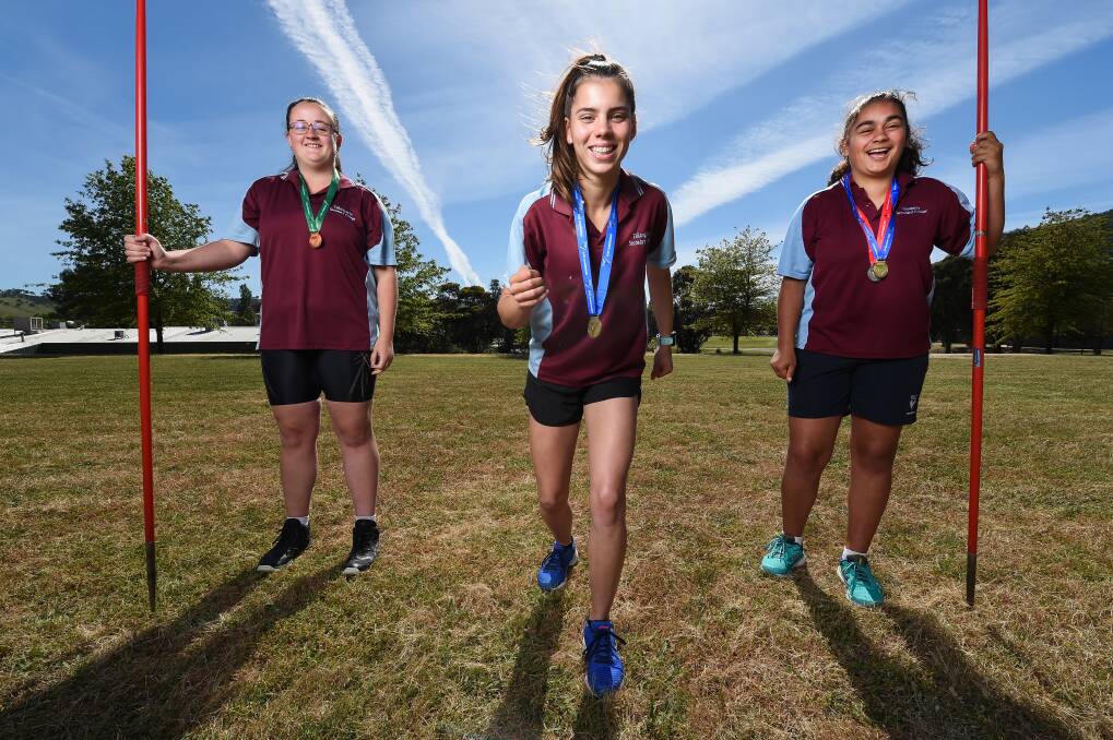 ON YOUR MARKS: Tallangatta Secondary College's Clare McCormack, Summer Sutherland and Dakira Cooper with the medals they recently won at a school state athletics carnival. Picture: MARK JESSER.