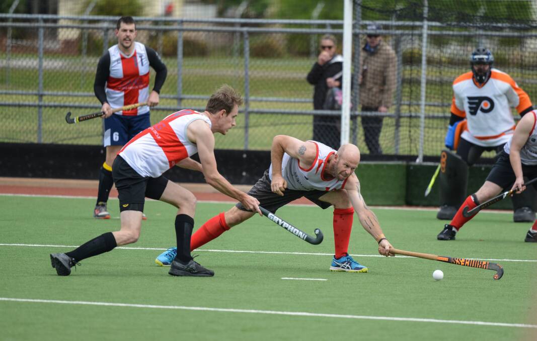 DETERMINED: Grey's Mat Russell reaches long to stop an attack from David Smith during round six of the hockey season last weekend. Picture: NARELLE HAMILTON