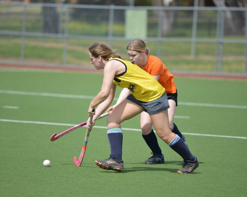 TIGHT TUSSLE: Erin OBrien and Abigail Case go head-to-head as they race to claim possession of the ball.