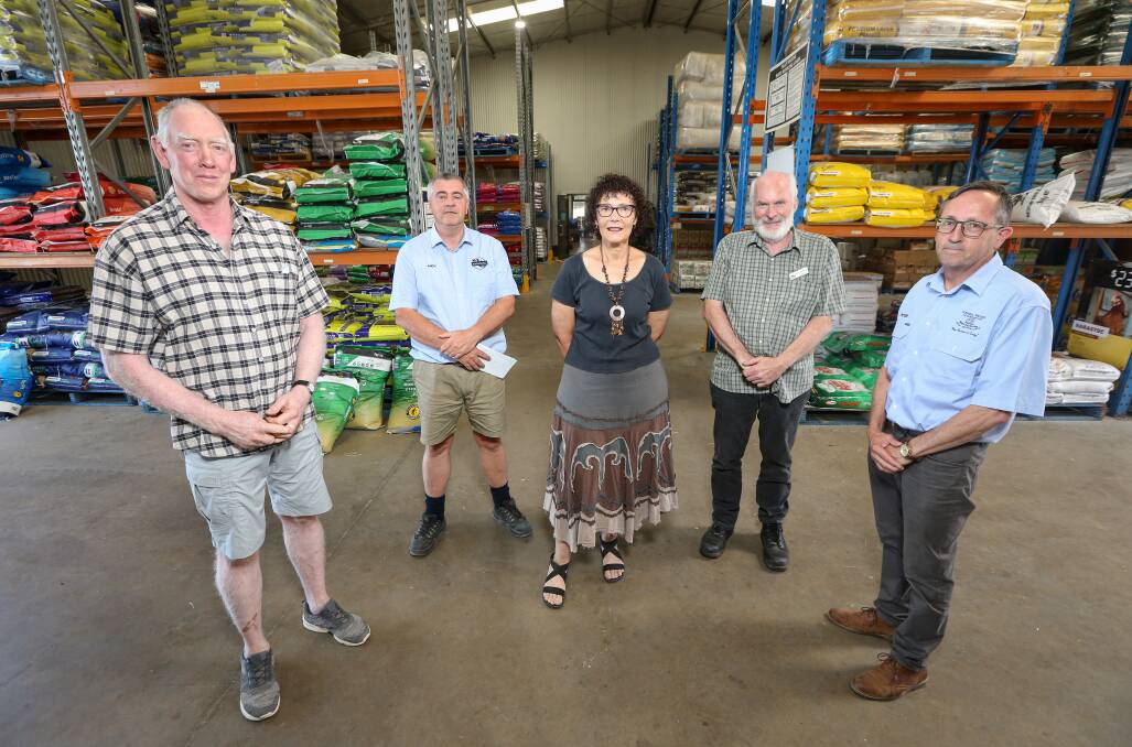 HELPING HAND: Terry Greaves, Andy Norling, Helen Young, Peter Matthews and Peter Calabria at NorMac Rural in Baranduda yesterday where the business donated money from their Christmas party fund to several border charities. Picture: JAMES WILTSHIRE