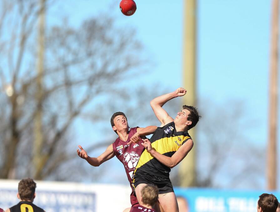 STRONG CONTEST: Wodonga's Rhys Venturoni and Albury's Pacey Maher go head-to-head during the grand final on Sunday.