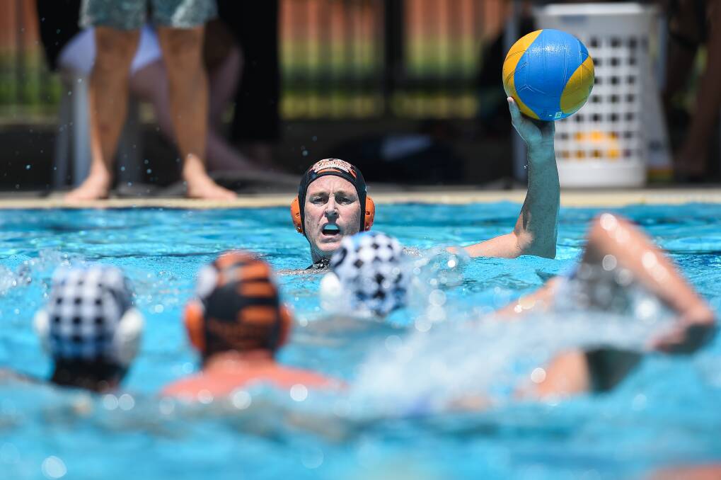 SPLASHING AROUND: Albury's Michael Sinclar looks for his Tiger teammates over the water during their clash with Sharks in Albury on Saturday. Picture: MARK JESSER.