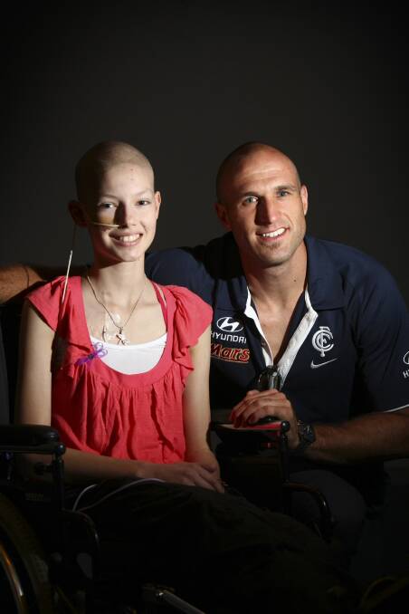 Imogen with Carlton football legend Chris Judd in 2010 during a fundraiser held in Albury.