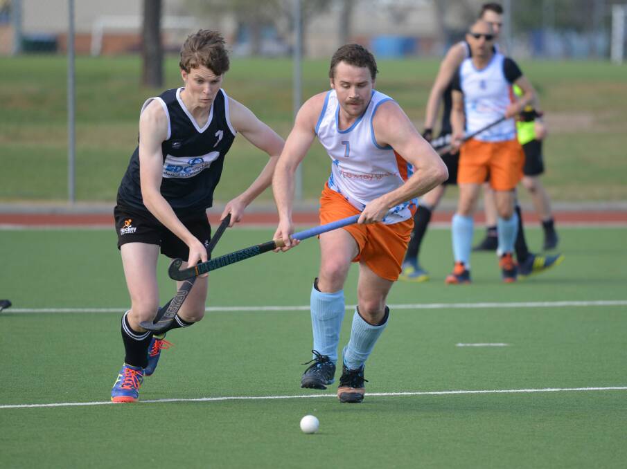 RACE ON: David Foster and Ryan Heagney locked in for a frantic race for the ball in men's hockey action on the weekend. Picture: NARELLE HAMILTON