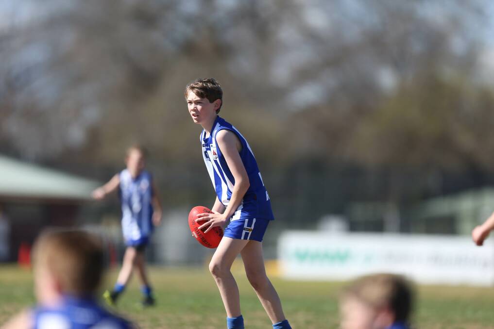 FOCUSED: Corowa-Rutherglen's Ethan Lane looks for teammates during the under-12's junior football grand final on the weekend.