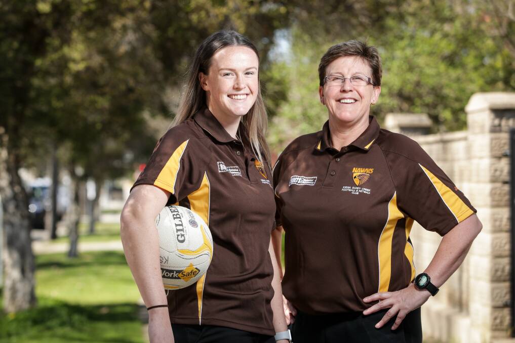 MUM'S THE WORD: Kiewa Sandy-Creek's mother-daughter duo Rebecca and Kath Evans have their eye on a Hawks' flag. Picture: JAMES WILTSHIRE