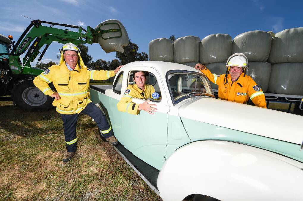 DRIVE AWAY: Howlong Fire Brigade members Clinton Franks, Rorey McNamara and David Lewis with the restored Ford Prefect that will be up for auction on Sunday at the Monster Auction. Picture: MARK JESSER