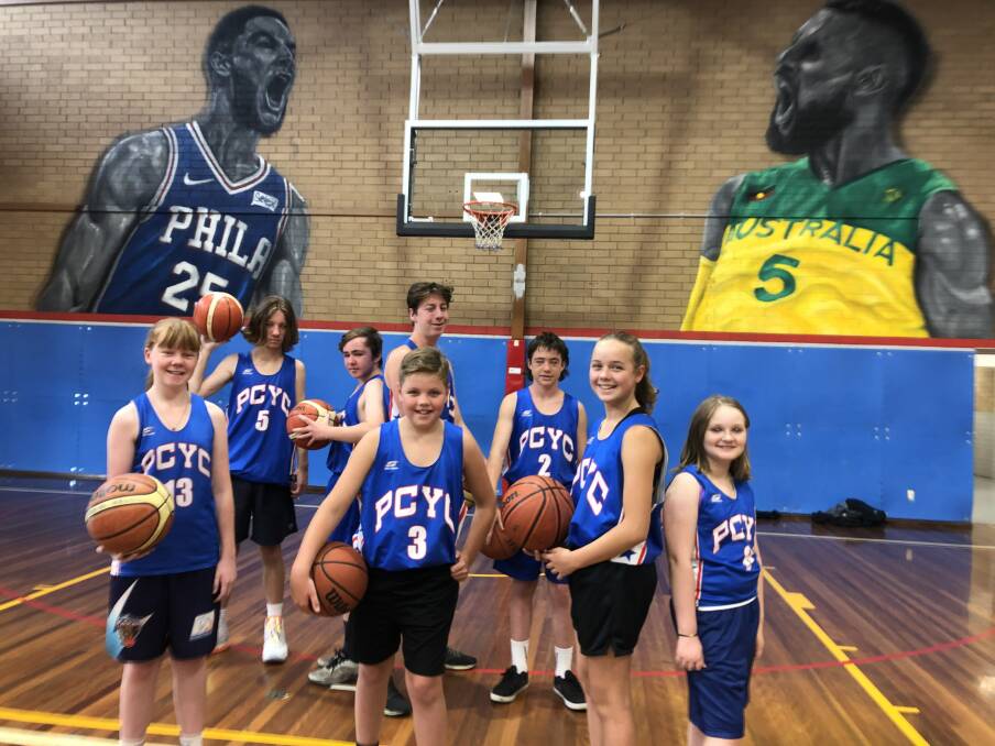 YOUNG TALENT: PCYC Basketball Club junior players enjoying the facilities in Albury as they're looked over by professional Australian basketballers Ben Simmonds and Patty Mills on the walls.