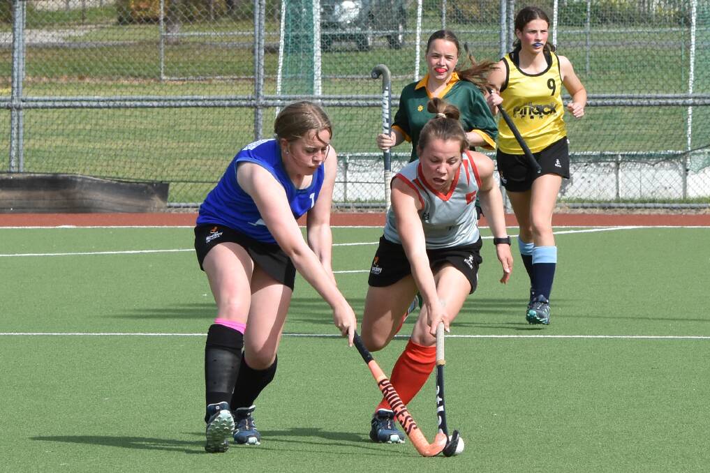 GAME ON: Avie Liley and Pip Bowler battle for the ball during round five of Hockey Albury-Wodonga's eights competition. Picture: GORDON ARNOLD