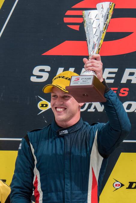 GOOD WAY TO END: Border racing product Jordan Boys displays his trophy on the podium in Newcastle after a stellar weekend of racing. Picture: TIM FARRAH.
