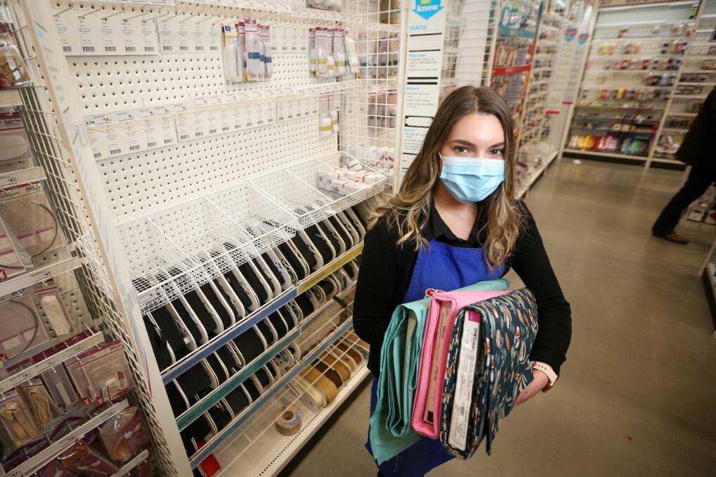 HIGH DEMAND: Albury Spotlight's Erin Woodward in front of the once filled shelves as elastic sells out across the Border with residents making their own face masks. Picture: JAMES WILTSHIRE
