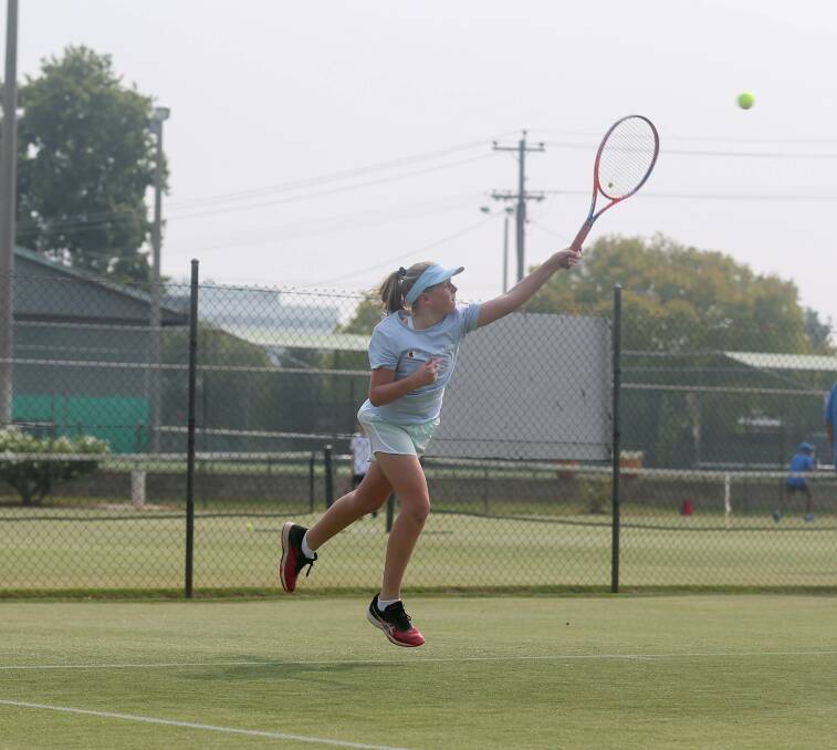 PLAY: Up and coming Border tennis star Indi Paton sends down a serve to her opponent at the Margaret Court Cup teams event in Albury on Thursday. Pictures: TARA TREWHELLA.