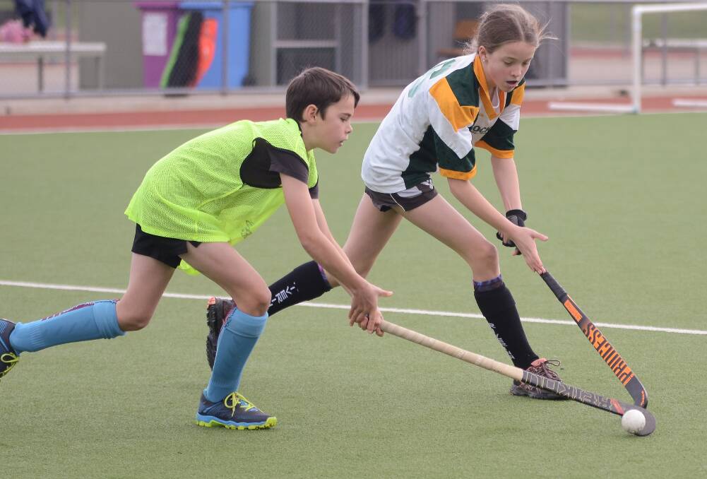 Ajay Heagney and Alice Eggleton go for the ball.