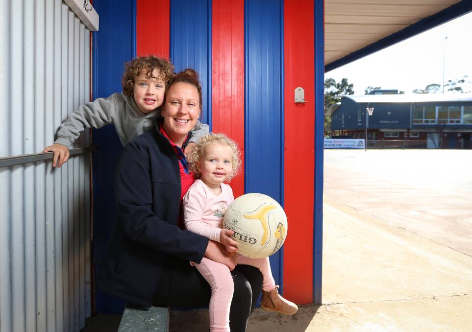 RUNS IN THE FAMILY: Beechworth netballer and A-grade co-coach Coby Surrey with her kids, Cooper, 5, and Eleanor, 2 at the town's home ground. Surrey has notched up 250 senior games with the club. Picture: JAMES WILTSHIRE