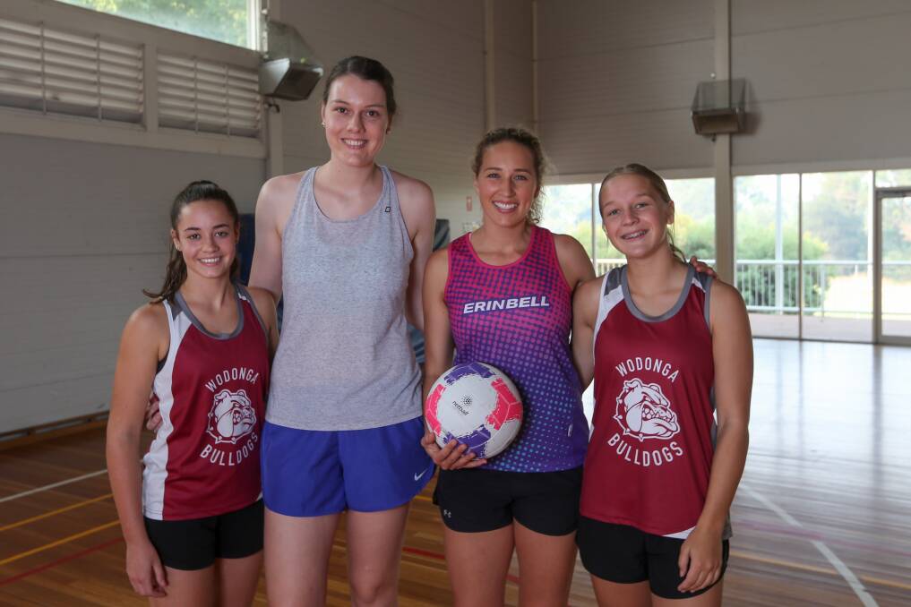 PLENTY OF TALENT: Wodonga Bulldogs' Maddie McFarland and Ellie Ainsworth with former Wodonga netballer Jane Cook and former Australian netballer Erin Bell at a training session at Kelly Park on Sunday. Picture: TARA TREWHELLA.