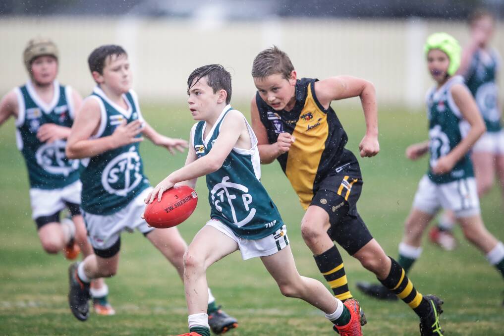 LOOK OUT:: St Pats' Ethan Read and Albury's Bill Butko playing in the under-12's competition during the season. Both team's will play in the finals this weekend.
