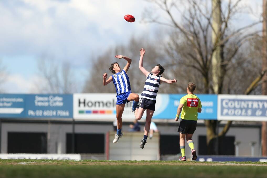 FLYING HIGH: Corowa-Rutherglen's Harrison Kay and Yarrawonga's Beau Cummins go up in the ruck during the under-14's grand final decider. Pictures: TARA TREWHELLA.