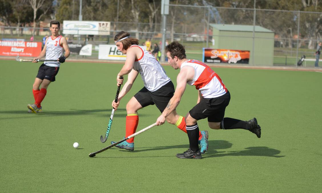 UP AND RUNNING: Brodie Hamilton has the lead on Rhys Llewelyn during the modified Hockey Albury-Wodonga competition on the weekend.