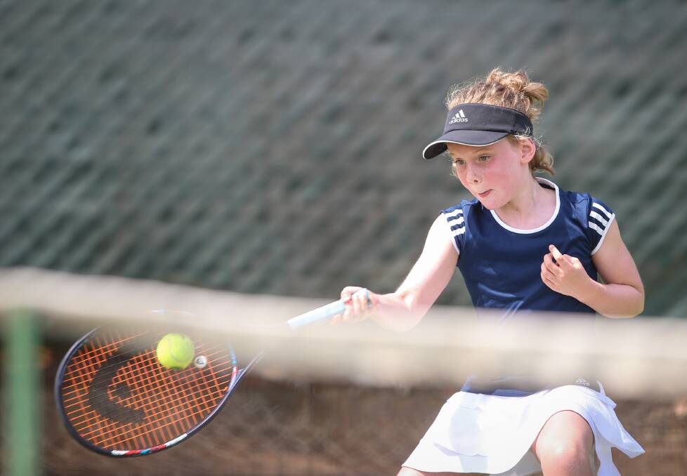 YOUNG GUN: Border tennis star Victoria Moscher gives her all during an under-10's match at the Albury grasscourts on Friday.