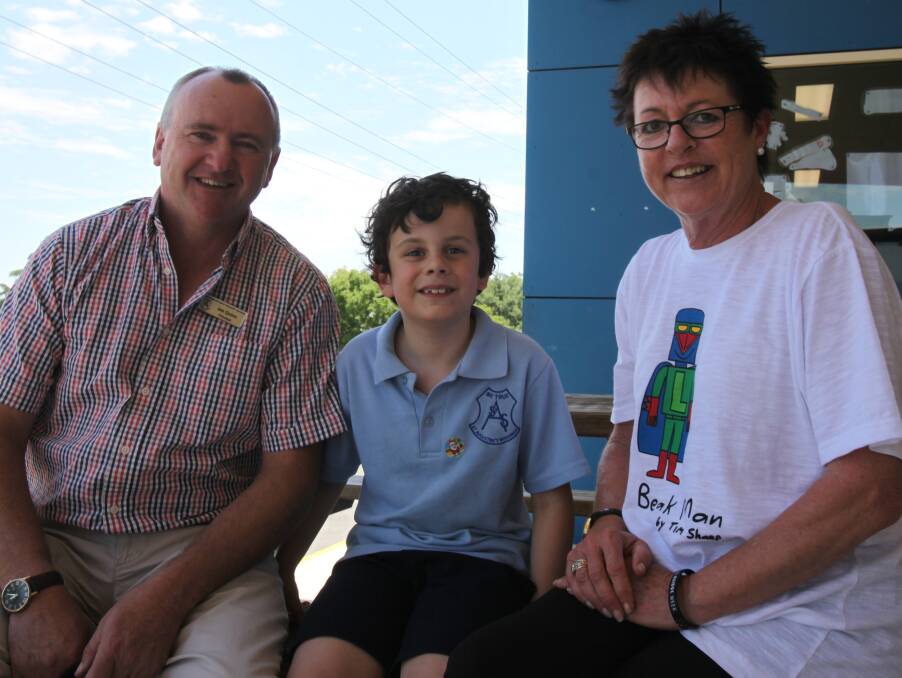 TRIO: St Augustine's principal Joe Quinn, student Paddy Mayhew, 8, and education support officer Gabby Dodd support I Can Ovens and Murray.