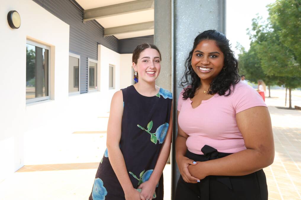 TEXTBOOKS DOWN: Trinity Anglican College year 12 students Faye Cameron, 18, and Madhulikaa Sarjapuram, 16, both attained the HSC All-rounder awards for a top band result in at least 10 units. Picture: JAMES WILTSHIRE