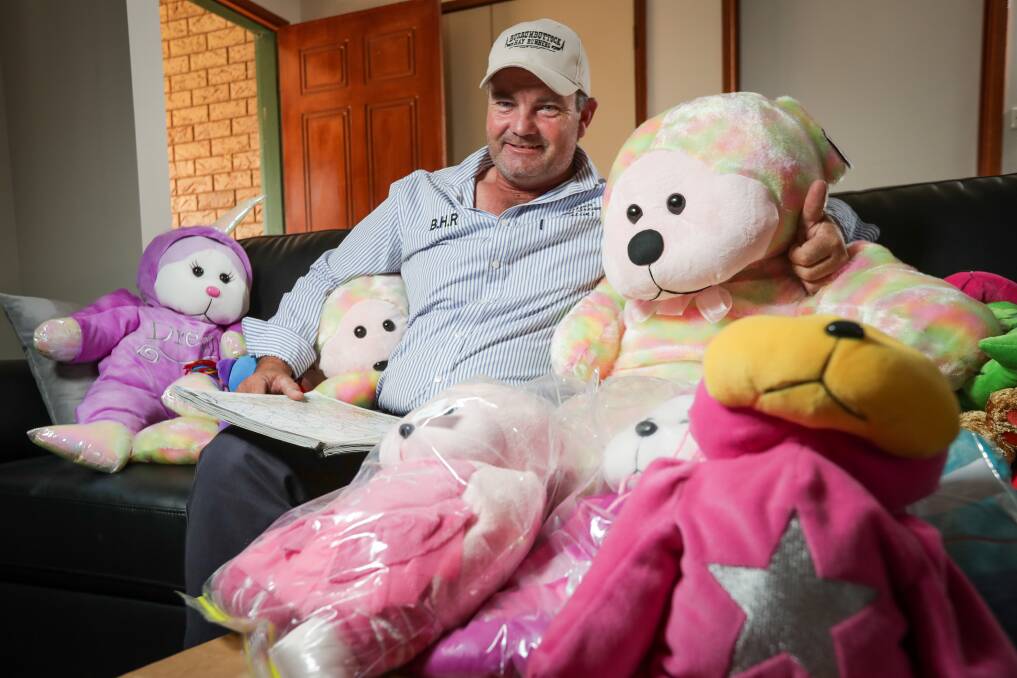 SOFT TOUCH: The normally feisty Brendan Farrell surrounded by donated toys for drought-stricken families. Picture: JAMES WILTSHIRE