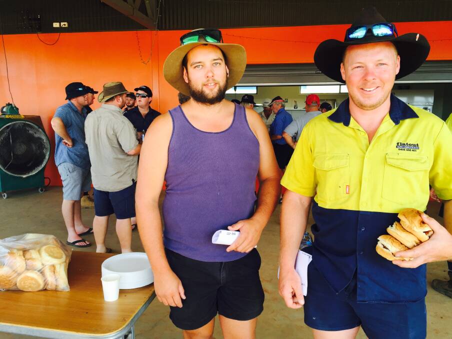 FUEL FOR THE ROAD: Brad Byrnes, 26, and Jason Bennett, 31, from Hawkesbury, NSW stock up on egg and bacon rolls before on-farm deliveries. The truck drivers say the drought has been swept under the carpet and media attention on the issue is fleeting.
