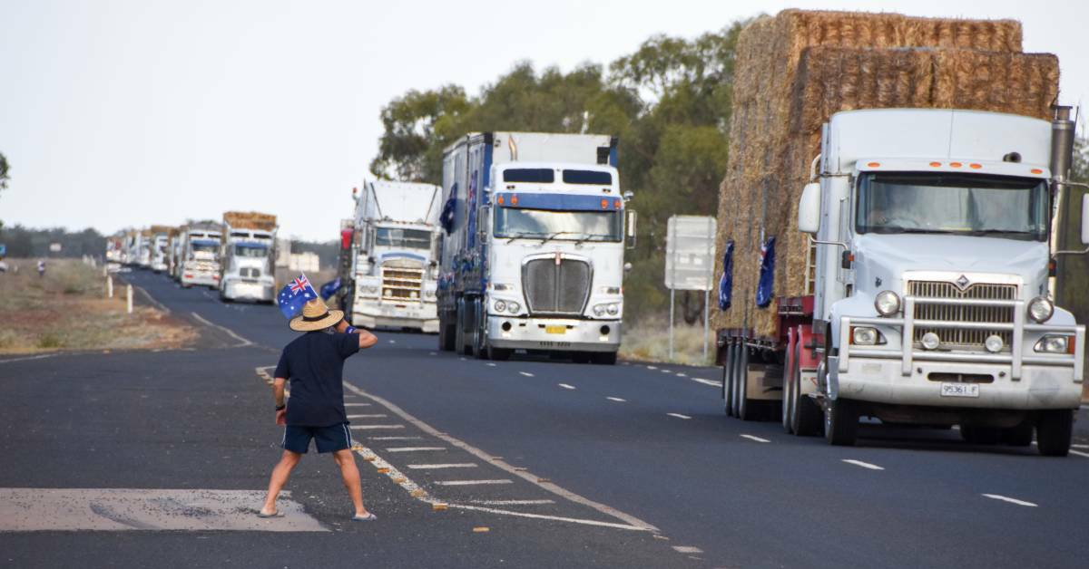 GOOD ON YA: A bystander waves on the convoy of trucks near Cunnamulla during the Burrumbuttock Hay Runners Australia Day 2018 mission. Picture: FAIRFAX