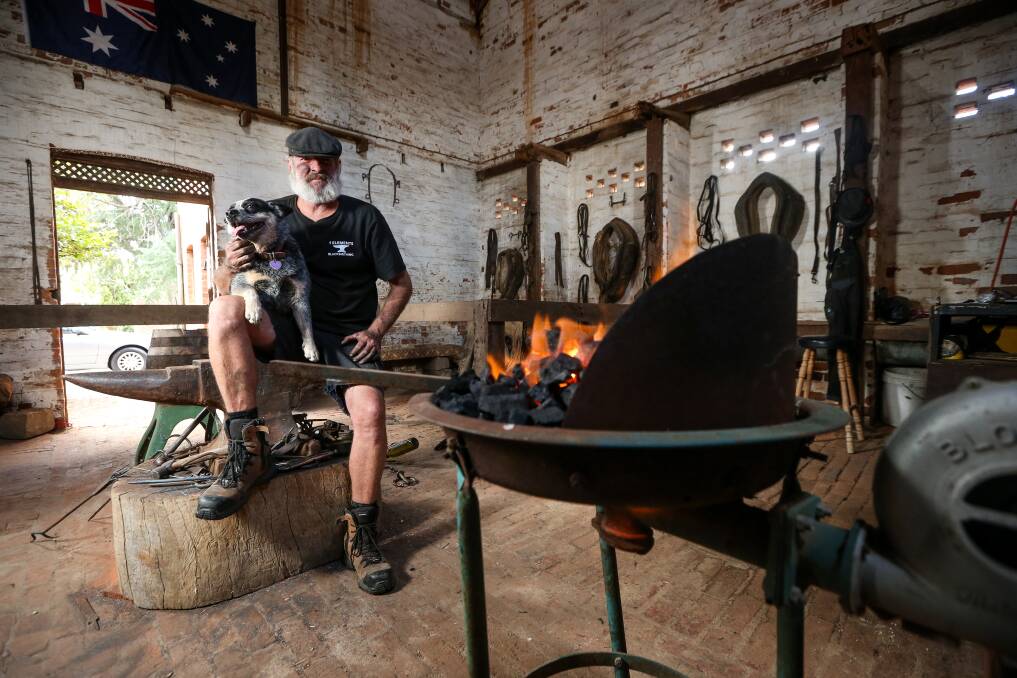 PERFECT SPACE: Brendan Thompson (pictured with his dog Roxy) has set up his blacksmith shop in the old stables at Rutherglen. PIctures: JAMES WILTSHIRE