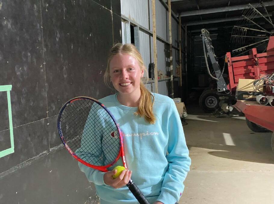 IT'S WORTH A SHOT: Indi Paton, 14, and her tennis-minded farming family turns to the Morven property's machinery shed for tennis practice when the weather is inclement. Picture: SUPPLIED