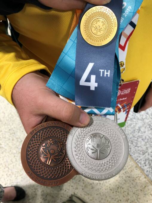 WORTH THEIR WEIGHT: Nathan's bronze and silver medals, and the fourth place medallion he also received in the 50-metre freestyle event in which he knocked eight seconds off his best time.