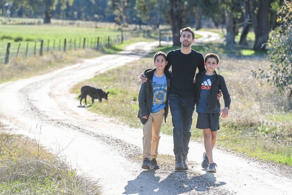 LOVE IS A WINDING ROAD: James Filby with sons Ari, 12 and Lawson, 11, on the road to their house, which has now officially been named 'Danelle Lane' ... 'you have to learn to have a relationship with grief'. Picture: MARK JESSER