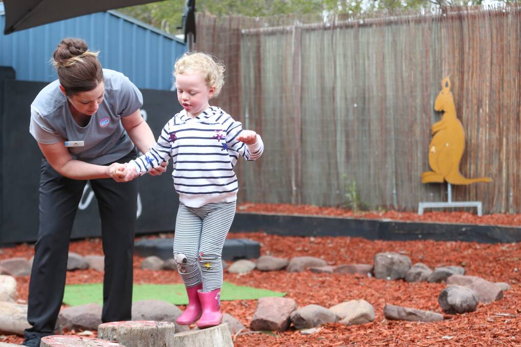 STEPPING STONES: Norah (O'Sullivan) Heath, who has Williams Syndrome, supported by Bek Eyers from Goodstart, Pemberton Street, Albury. Picture: JAMES WILTSHIRE